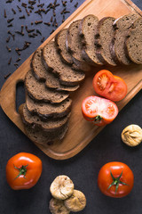 fresh tomatoes with homemade bread, lying on the wooden Board
