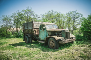 Obraz premium Старый ржавый грузовик на деревенской дороге
