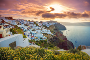 Oia town on Santorini island, Greece. Traditional and famous houses and churches with blue domes...