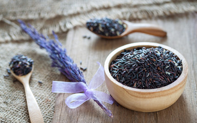 Rice berry in a bowl on wooden background
