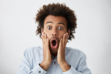 It's a boy! bug-eyed African male with funky hairstyle screaming, opening mouth wide opened and...