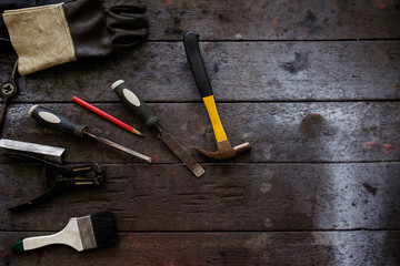 Inverted welding machine welding equipment on a wooden desk with workshop background welding mask leather gloves welding electrodes high-voltage wires with clips set of accessories for arc welding.