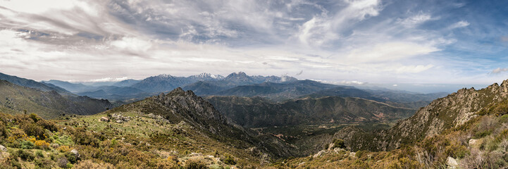 Dramatic panoramic view of snow capped mountains of northern Corsica
