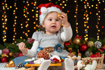 child girl portrait in christmas decoration, happy emotions, winter holiday concept, dark background with illumination and boke lights