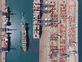 Commercial port with container ships - Top down aerial view.