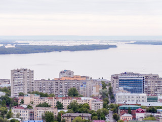 The city's skyline. The Russian province of Saratov. High-rise residential buildings, the Volga river and the railway bridge on the horizon
