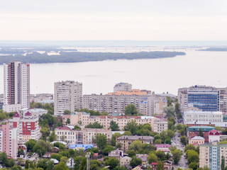 The city's skyline. The Russian province of Saratov. High-rise residential buildings, the Volga river and the railway bridge on the horizon