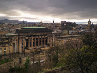 Fototapeta premium Edinburgh city on dark sky with black clouds view from Calton Hill, Scotland, UK
