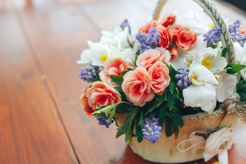 beautiful flowers in wooden basket handmade on wooden background