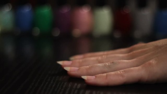 red nail polish and nail lacquers in the background