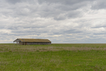 Old abandoned building on a green field