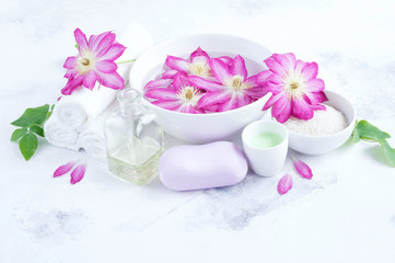 Fototapeta na wymiar Massage and Spa products with flowers clematis