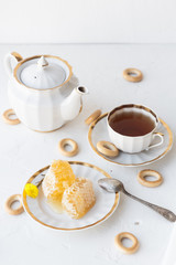 Tea with honey on white background