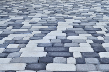 A detailed photo of the square, laid out of modern paving stone with rounded corners. Accurate design of pedestrian areas