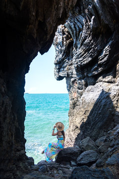 Travel women in a cave near the sea in Keo Sichang, Thailand