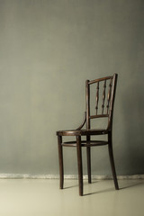 old wooden chair on Grey grunge textured handmade background wall Copy space.for portrait