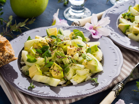 Green Avocado cucumber salad with lettuce, apple and pumpkin flex sunflower seeds. Diet detox food lunch
