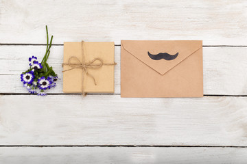 Happy Fathers Day  gift box on white wooden background. flat lay