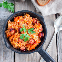 Stewed cabbage with carrots and hunting sausages, square