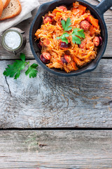 Stewed cabbage with sausages, German cuisine, horizontal, copy space, top view