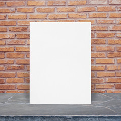 Blank White paper poster on stone table top at old brick wall,Template mock up for adding your design.