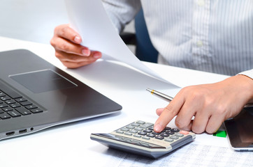 Businessman using a calculator to calculate the numbers. Accounting , Accountancy, Calculation...