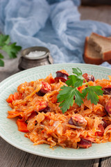 Cabbage stew with grilled sausage - traditional dish of german cuisine, Selective focus