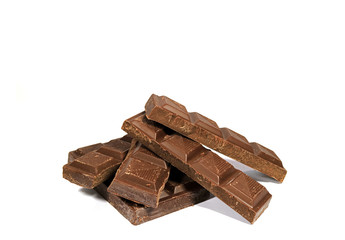 Piled Up Dark Chocolate Bar Pieces Isolated on White Background, with free space for text and design 