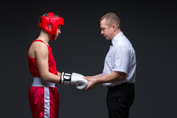 Referee checking young boxer