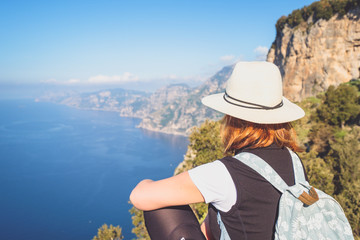 Young woman admiring a beatuful landscape view of Amalfi coast