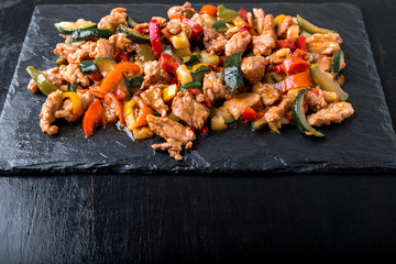 Beef Fajitas with colorful bell peppers in slate plate.  Top view.