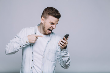 Smiling young man with beard in a white shirt