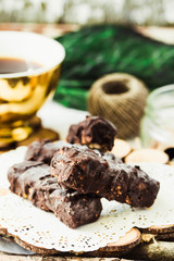 Homemade raw chocolate candy. Snickers bars with cup of coffee.