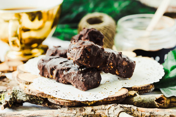 Homemade raw chocolate candy snickers bars. Vegan dessert.