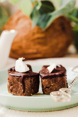 Raw chocolate candy with nuts and coconut, healthy vegan dessert