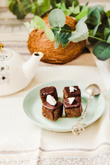 Raw chocolate candy with nuts and coconut, healthy vegan dessert