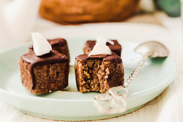 Raw chocolate candy with nuts and coconut, healthy vegan dessert