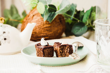 Raw chocolate candy with nuts and coconut, healthy vegan dessert