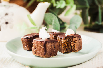 Raw chocolate candy with nuts and coconut, healthy vegan dessert