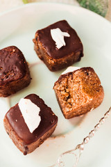 Raw chocolate candy with nuts and coconut, healthy vegan dessert