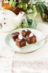 Raw chocolate candy with nuts and coconut, healthy vegan dessert