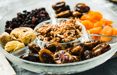 Assorted dried fruits and nuts on a glass plate