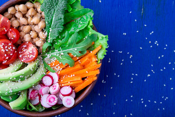 Buddha bowl on blue wooden background. Vegetarian, healthy, detox food concept. Top view.
