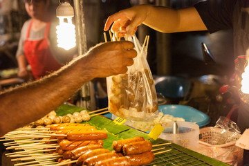 Man buys meatballs at the Chiang Mai Sunday Market