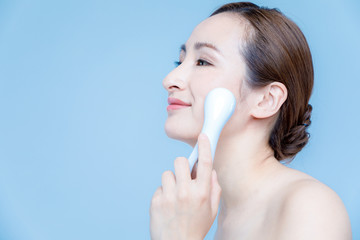 woman using handy ion introduction instrument. skincare concept.