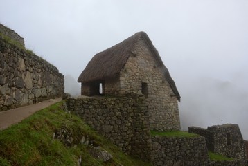 Fototapeta na wymiar Incan stone huts for grain storage, perched high in the cool air and clouds of the sacred valley.
