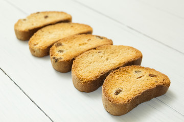 Sweet crocs with raisins on a white wooden table, diet food.