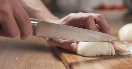 man cutting white onion with knife, 4k photo