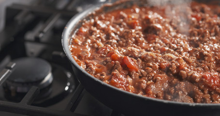 roasting minced beef with tomato paste in a pan, 4k photo