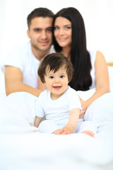 Fototapeta premium family with young children to bed in the bedroom